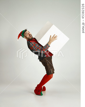 friendly man dressed like a funny gnome posing on an isolated gray background 45382326