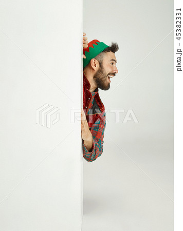 friendly man dressed like a funny gnome posing on an isolated gray background 45382331