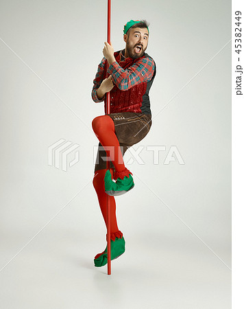 friendly man dressed like a funny gnome posing on an isolated gray background 45382449
