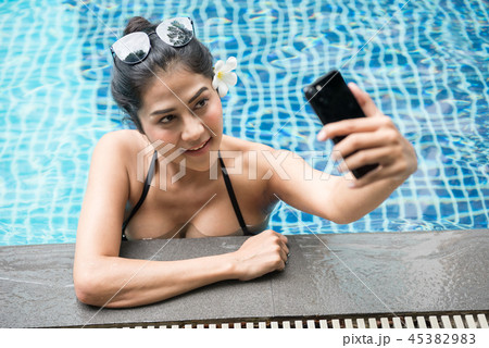 sexy Asian woman selfie in pool sexy Asian woman selfie in pool 45382983