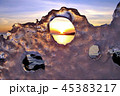 View of winter sunset through holes in ice 45383217