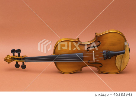 Musical instrument violin on a brown background Musical instrument violin on a brown background 45383943
