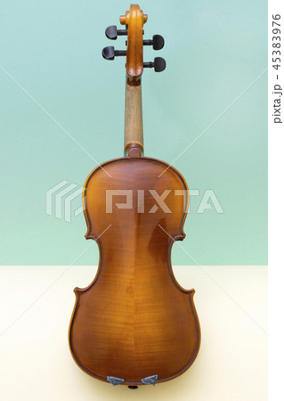 Musical instrument violin on a colored background Musical instrument violin on a colored background 45383976