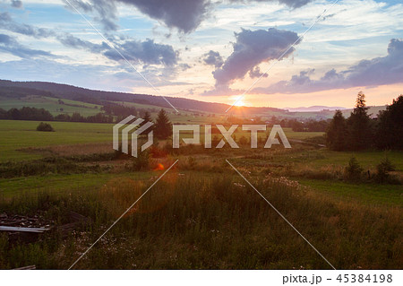 Sunset summer landscape. Clouds, trees and hill 45384198