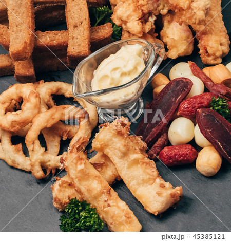 set of snacks for beer from crackers, onion rings, sausage and cheese 45385121
