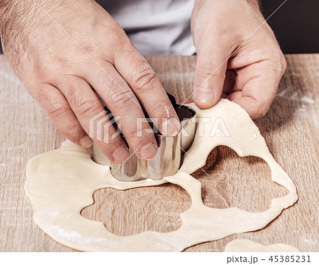 man using bakery mold for cookies 45385231