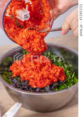 Chef pours pepper from the blender 45385233