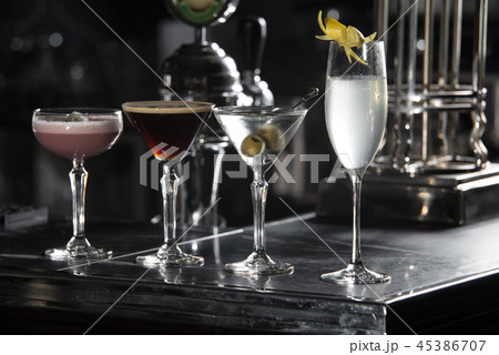 four special cocktails on a bar desk. black background four special cocktails on a bar desk. black background 45386707