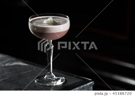 Porto Flip cocktail on a bar desk. black background 45386720