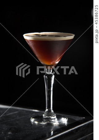 Espresso Martini cocktail on a bar desk. black background. Espresso Martini cocktail on a bar desk. black background. 45386725