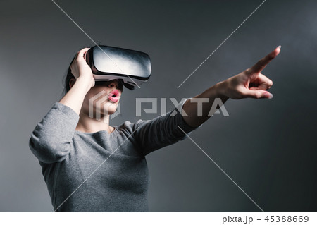 Young woman using a virtual reality headset 45388669