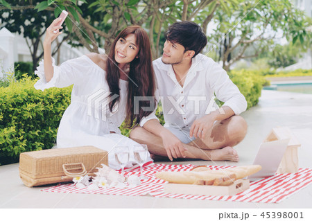 Young couple go picnic at the park in summer. 45398001