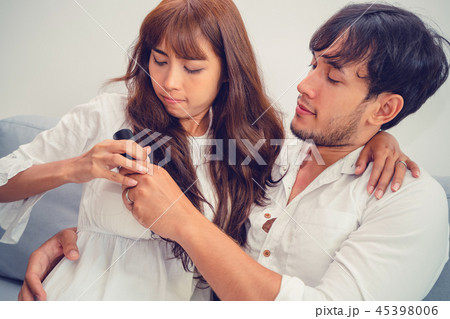 Couple fight fot TV remote in living room. Couple fight fot TV remote in living room. 45398006