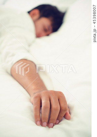 Young man sleep in bed in the bedroom. Young man sleep in bed in the bedroom. 45398007