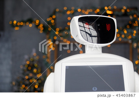 Humanoid autonomous robot on the background of Christmas decorations, Christmas tree, bokeh Humanoid autonomous robot on the background of Christmas decorations, Christmas tree, bokeh 45403867