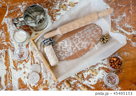 Rolling pin with a pattern on a wooden  table  45405153