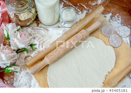 Rolling pin with a pattern on a wooden  table  45405161