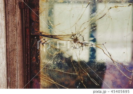 Cracked and broken window, Industrial background Cracked and broken window, Industrial background 45405695