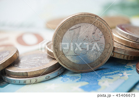 closeup of coins pile and banknotes in euro money 45406675