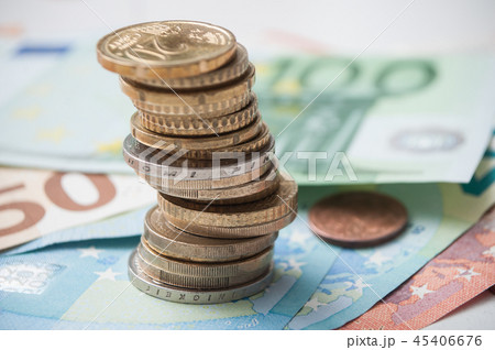 closeup of coins pile and banknotes in euro money 45406676