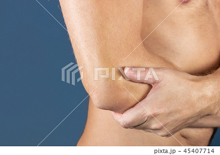 The man holds the elbow due to acute pain 45407714