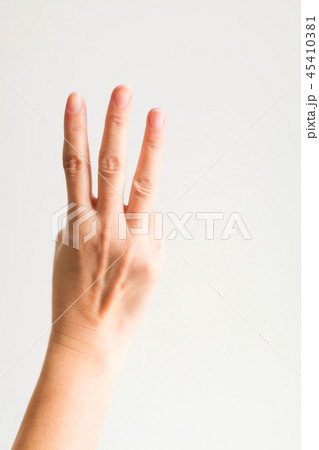 A hand showing three fingers for counting three. 45410381