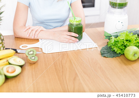 Preparing detox fruits smoothie in blender 45410773