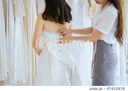 Asian bride trying on wedding dress Asian bride trying on wedding dress 45410858