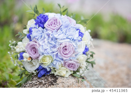 A floral wedding bouquet in bride`s hands in her b 45411365