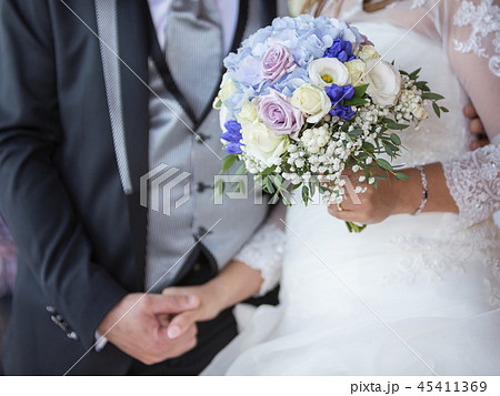 A floral wedding bouquet in bride`s hands in her b 45411369