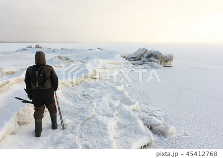 Man in walking on the a frozen Ob Reservoir,Russia 45412768