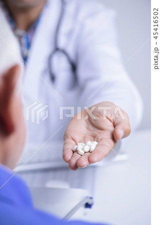 doctor man giving some pills to a senior man 45416502