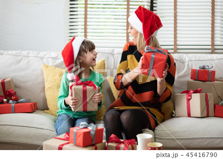 Happy mother and her daughter holding gift boxes. 45416790