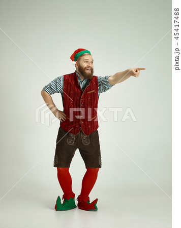 friendly man dressed like a funny gnome posing on an isolated gray background 45417488