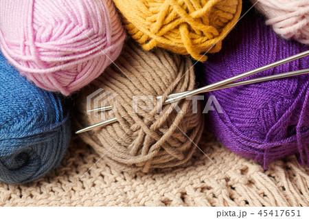 ball of wool yarn for knitting on wood background  45417651
