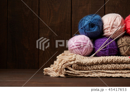 ball of wool yarn for knitting on wood background  45417653
