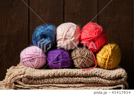 ball of wool yarn for knitting on wood background  45417654