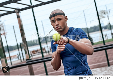 An african man is boxing with tennis ball at open air gym 45421132