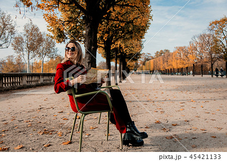 girl sitting in chair in a park in Paris 45421133