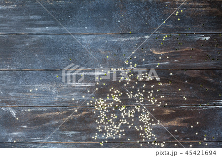Dark wooden background with golden confetti Dark wooden background with golden confetti 45421694