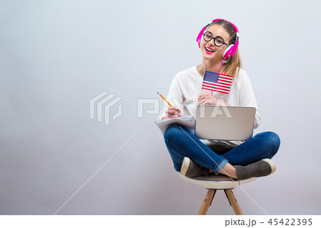 Young woman with USA flag using a laptop computer 45422395