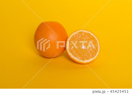Orange on yellow background. Ripe tropical fruit 45425451