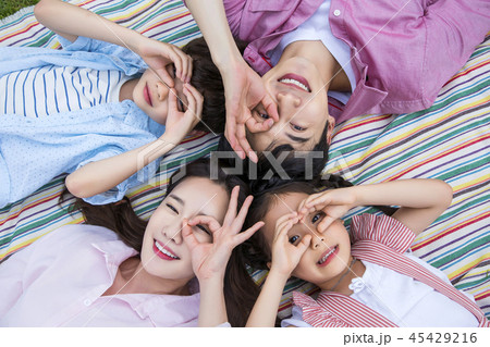 Family having picnic outdoors. Parents with two children relax in the park. Concept of happy family relations and carefree leisure time. 102 Family having picnic outdoors. Parents with two children relax in the park. Concept of happy family relations and carefree leisure time. 102 45429216