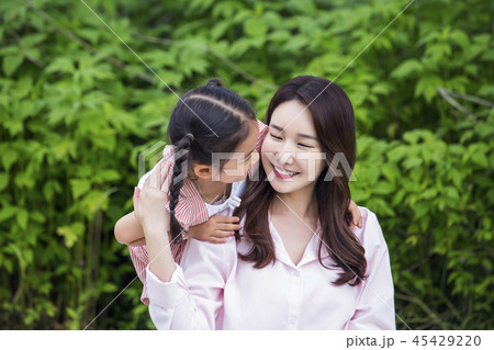Family having picnic outdoors. Parents with two children relax in the park. Concept of happy family relations and carefree leisure time. 100 45429220