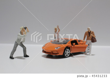 small figure with the toy sport car small figure with the toy sport car 45431233