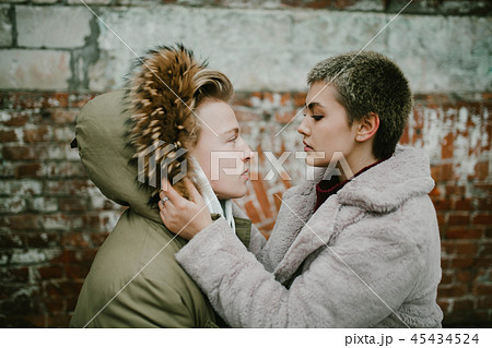 a girl holds a guy in the hood 45434524