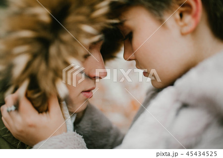 a girl holds a guy in the hood 45434525