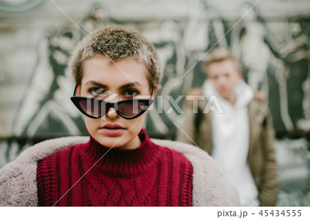 Girl with short hair in black sunglasses on the street 45434555