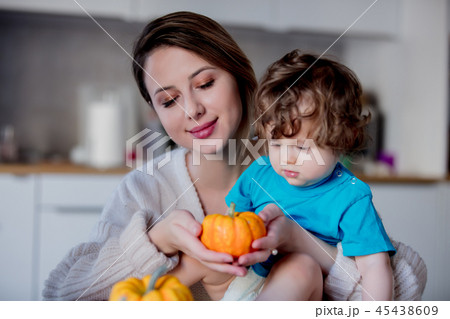 Happy mother and son with pumpkin. 45438609