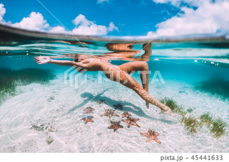 Beautiful woman floating and relax in tropical sea 45441633